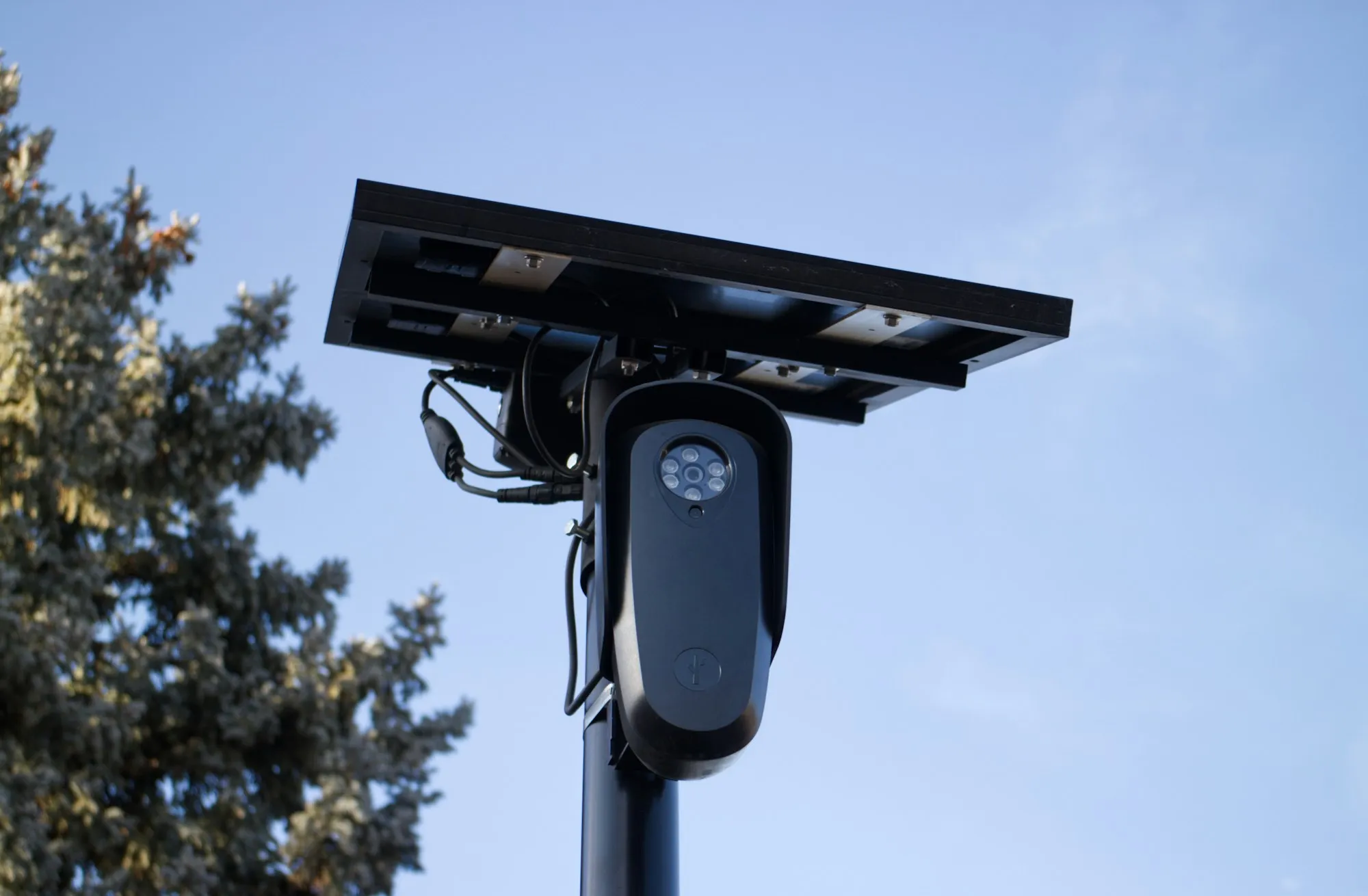 Solar-powered security camera mounted on a pole